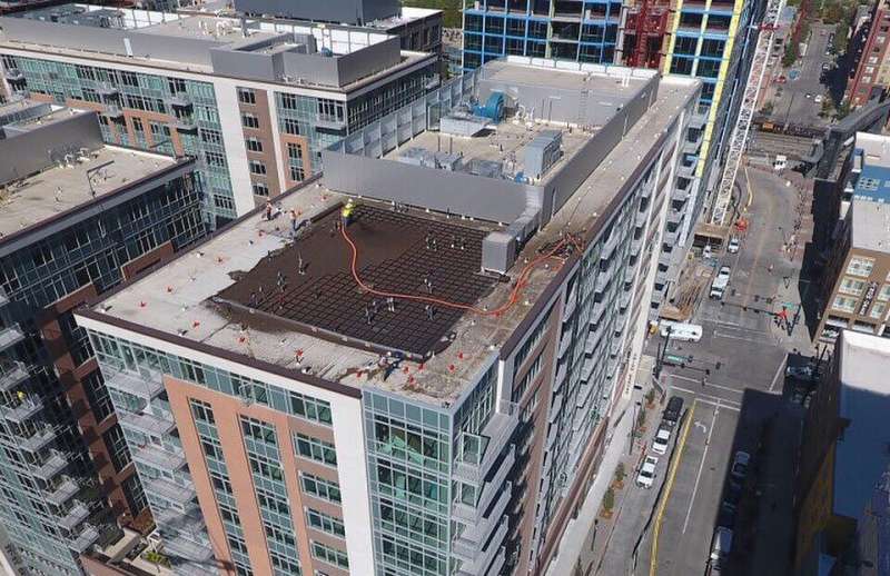 blower truck placed lightweight rooftop soil 165ft vertical feet onto a 13th floor rooftop deck in Colorado Green Roofs
