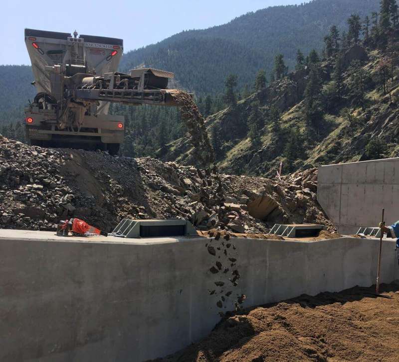 Bedrock Slingers aiding in building a new bridge on highway 34 in big thompson canyon by backfilling hard to reach areas to keep the project moving.