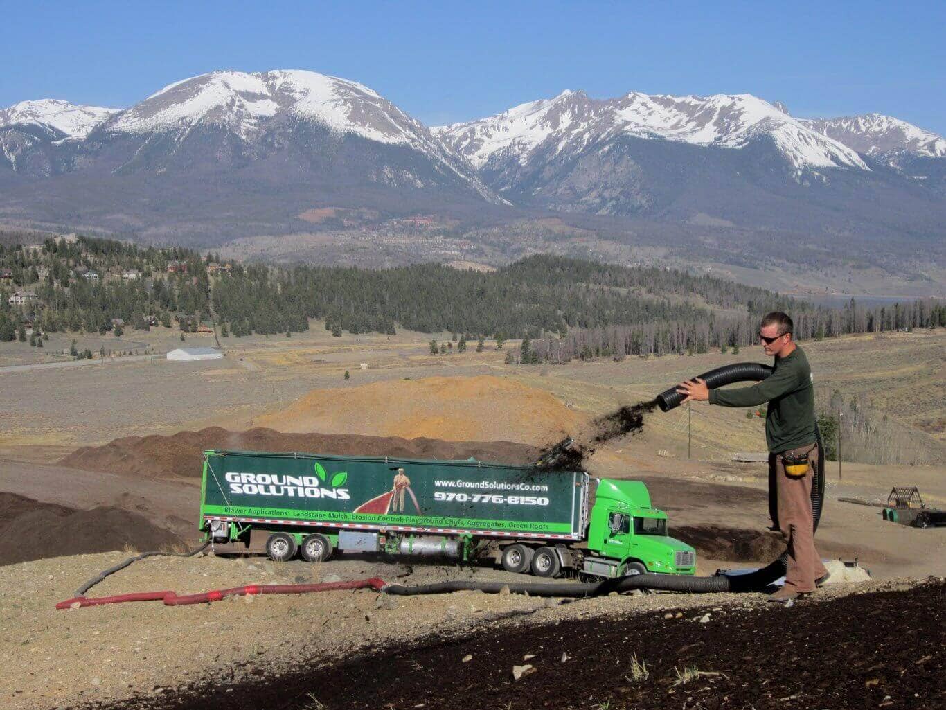 Ground Solutions placing compost blanket with seed injected over a slope inside the Summit County landfill property.